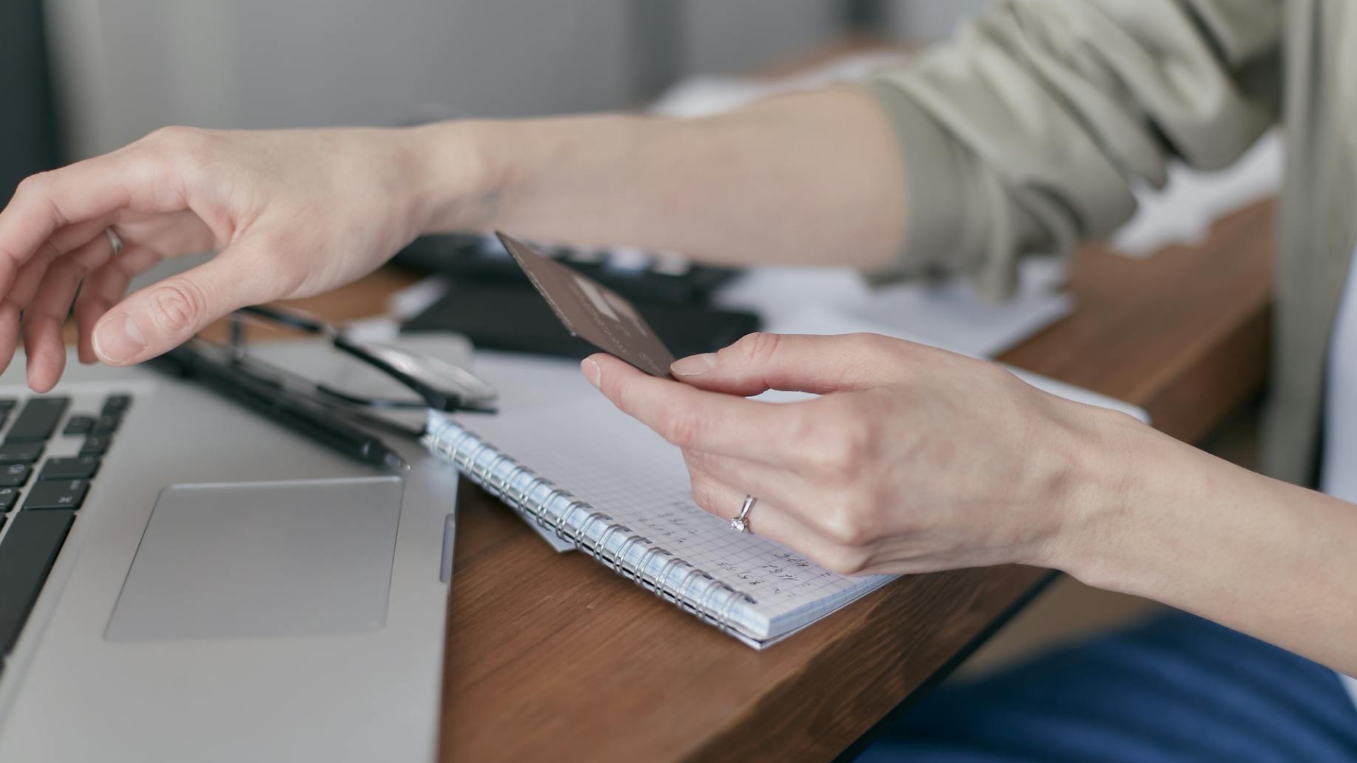 Person processing a payment on their laptop