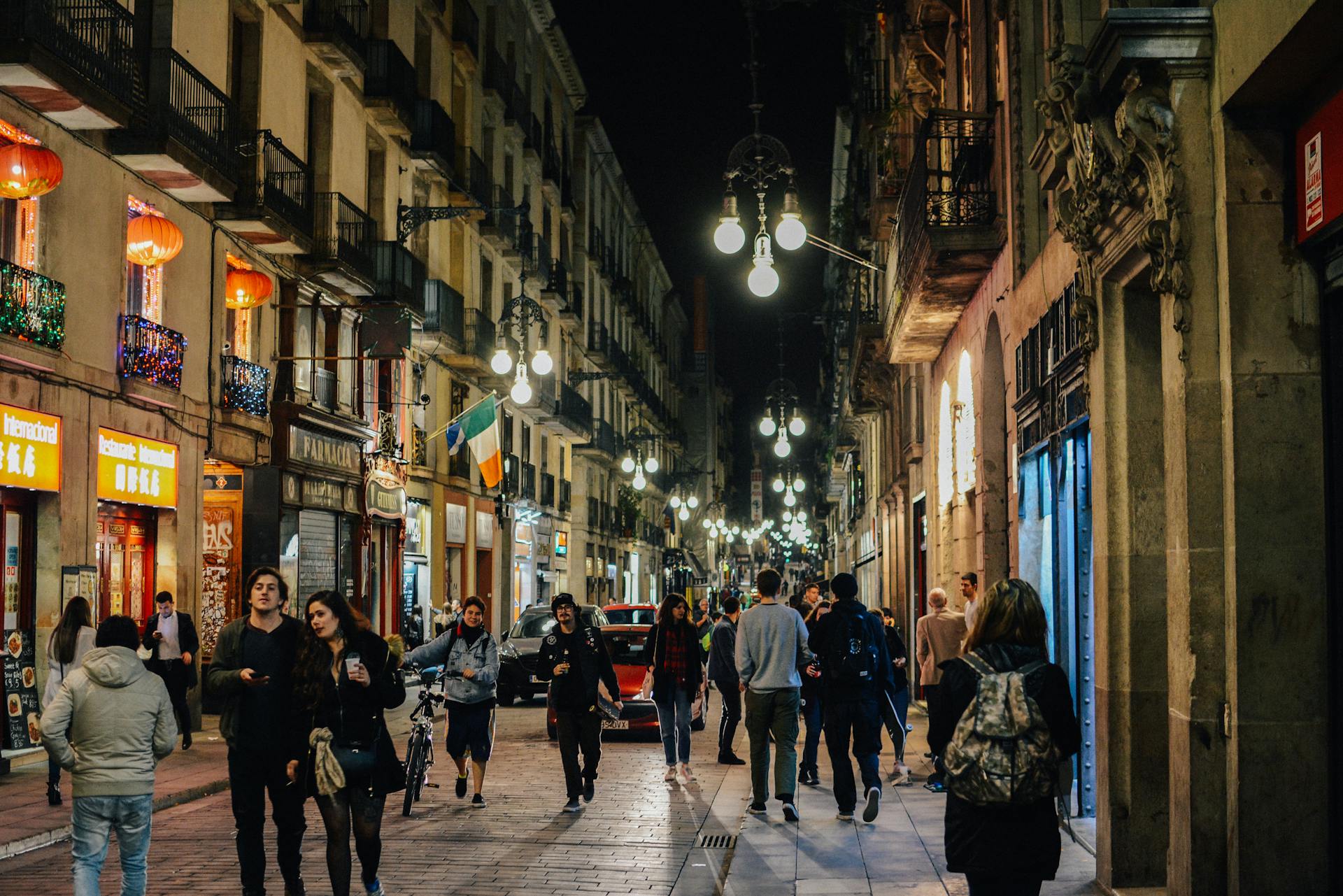Busy street in Barcelona after dark.